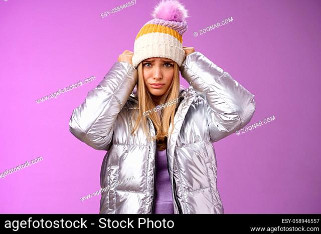Upset gloomy complaining blond girlfriend whining standing upset disappointed sulking offended pulling hat forehead look offended unhappy wearing stylish...