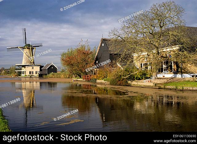 Farm buildings and windmill De Vriendschap along the river Graafstroom in the Dutch village Bleskensgraaf