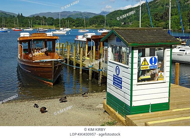 England, Cumbria, Ambleside, The Queen of the Lake pleasure boat tied to a jetty on the shore of Lake Windermere at Ambleside