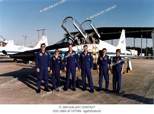 Members of the flight crew pose alongside a T-38 jet trainer aircraft after arriving at the Kennedy Space Center (KSC) Shuttle Landing Facility (SLF) for...