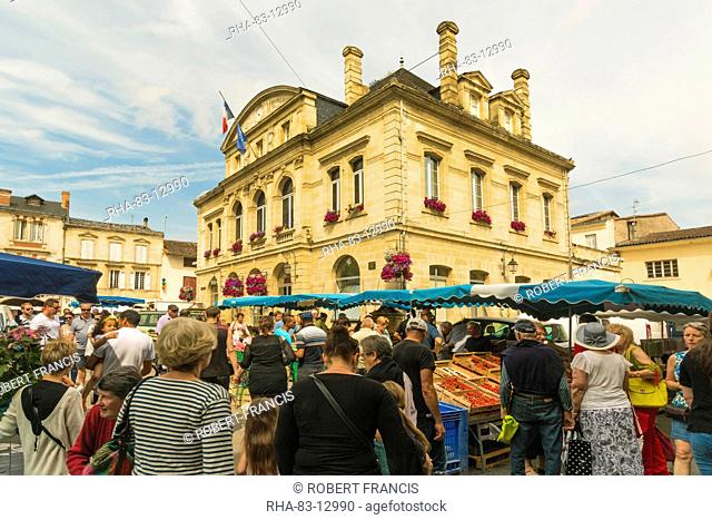 Stalls and the Mairie in town hall square on market day in this old bastide town, Sainte-Foy-la-Grande, Gironde, Aquitaine, France, Europe
