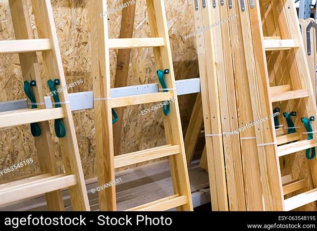 Many Wooden ladders. Stack of wooden stairs in the store