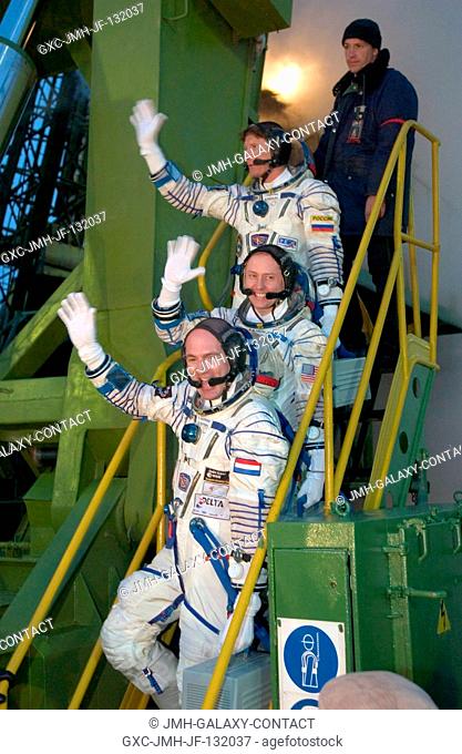 Attired in their Russian Sokol suits, cosmonaut Gennady I. Padalka (top), Russia's Federal Space Agency Expedition 9 mission commander; astronaut Edward M