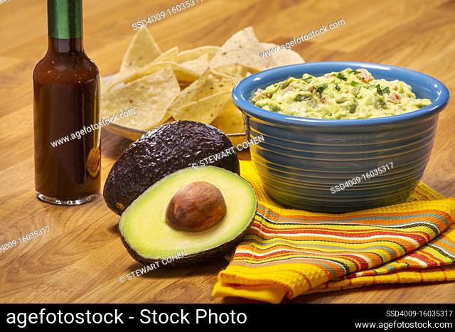 Guacamole and Chips with a red hot sauce