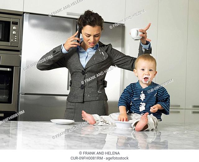 Working mother with son making a mess