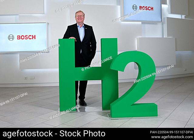 04 May 2021, Baden-Wuerttemberg, Renningen: Stefan Hartung, the chairman of the Bosch board of management, pictured in front of an H2 logo before the balance...