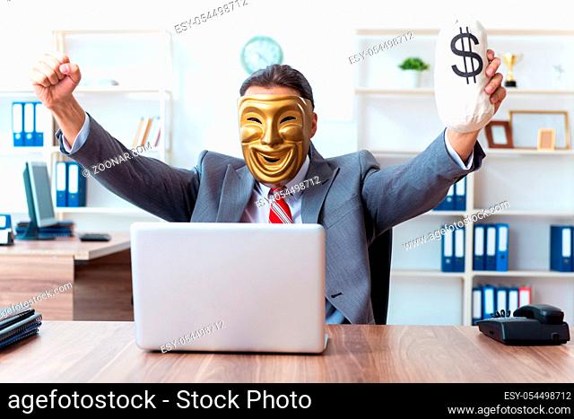 The businessman wearing mask in hypocrisy concept