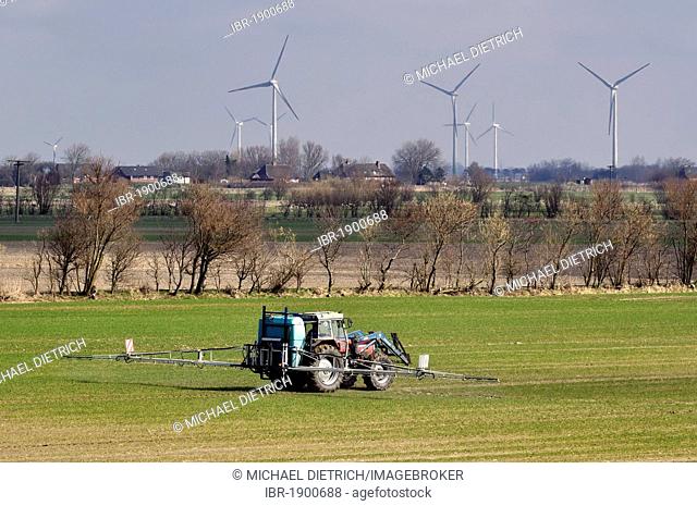 Intensive farming, farmer spraying pesticide, North Frisian marsh, North Friesland, Schleswig-Holstein, Germany, Europe