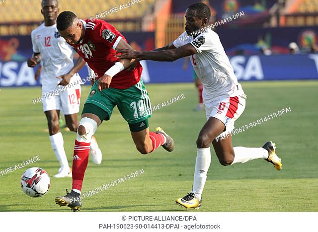 23 June 2019, Egypt, Cairo: Morocco's Youssef En-Nesyri and Namibia's Larry Horaeb battle for the ball during the 2019 Africa Cup of Nations Group D soccer...
