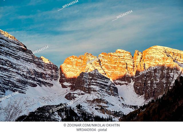 Maroon Bells mountains in snow at sunrise in Colorado Rocky Mountains, USA