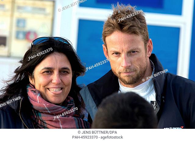 British Formula One driver Jenson Button of McLaren Mercedes posing for a photo with a female fan during the training session for the upcoming Formula One...