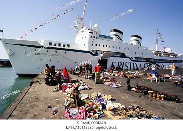 Tanji on the coast of Gambia is a port of call for the large cruise ships which travel along the coast, and there are stalls set up on the quayside by people...