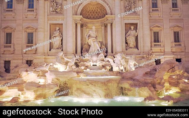 the famous trevi fountain with lights on in rome, italy
