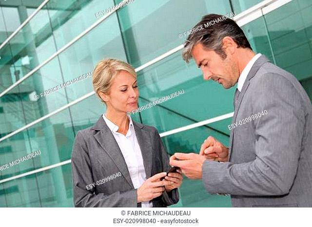 Business people exchanging phone numbers