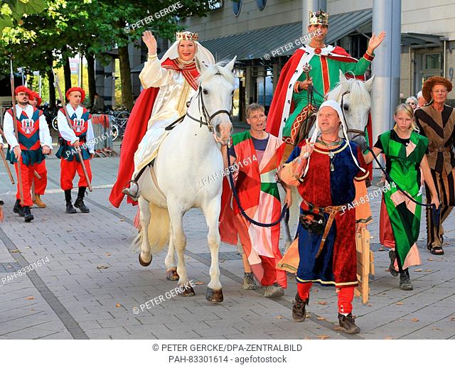 Dressed up as Queen Editha (r) and Otto the Great (l) particpants can be seen during the opening of the Emperor Otto festival in downtown Magdeburg, Germany