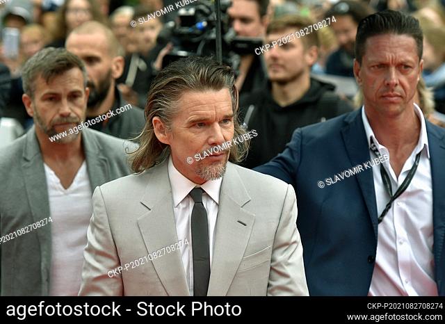 U.S. actor, writer and director Ethan Hawke, center, greets viewers when coming to red carpet and presented film Despair and Hope at 55th Karlovy Vary...