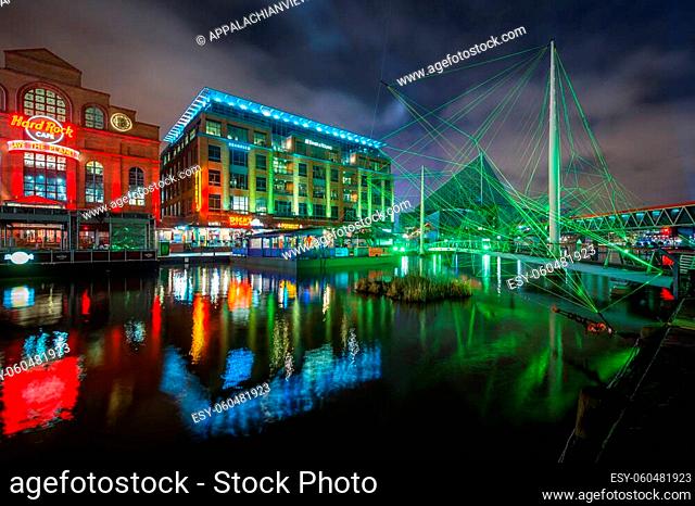 Pedestrian bridge and buildings at the Inner Harbor at night, in Baltimore, Maryland