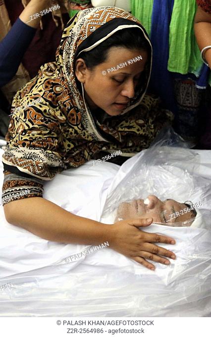 BANGLADESH, Dhaka : The wife of publisher Faisal Arefin Dipan, who was hacked to death, reacts next to his body in Dhaka on November 1, 2015