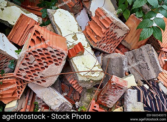 Pile of debris of a destroyed building, mostly roof tiles and bricks