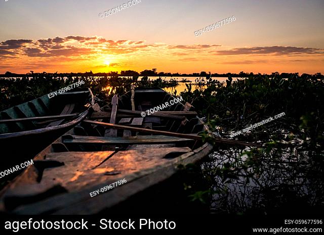 Fishermen's boats in Puerto Pollo at Rio Paraguay in Paraguay's Pantanal at sunset