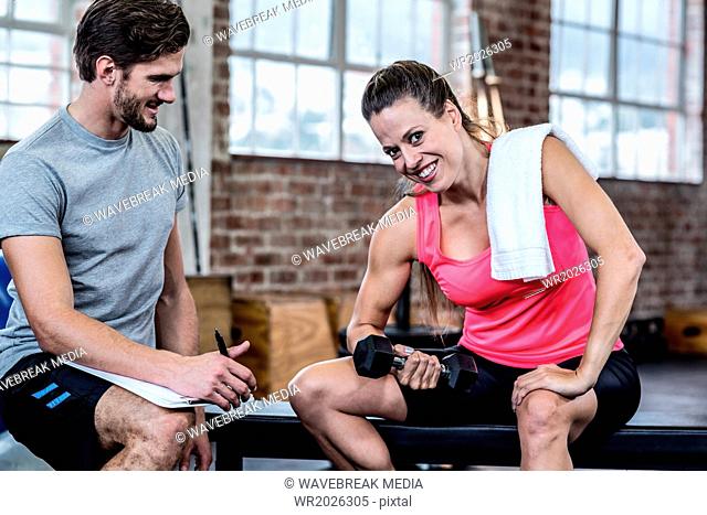 Smiling woman doing dumbbell exercises