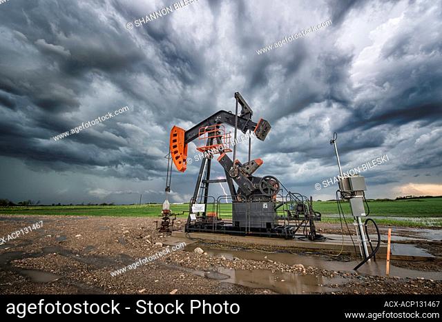 Storm and lightning rolls over oil pump in Southern Manitoba, Canada
