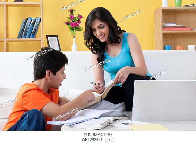 Sister helping her brother with homework