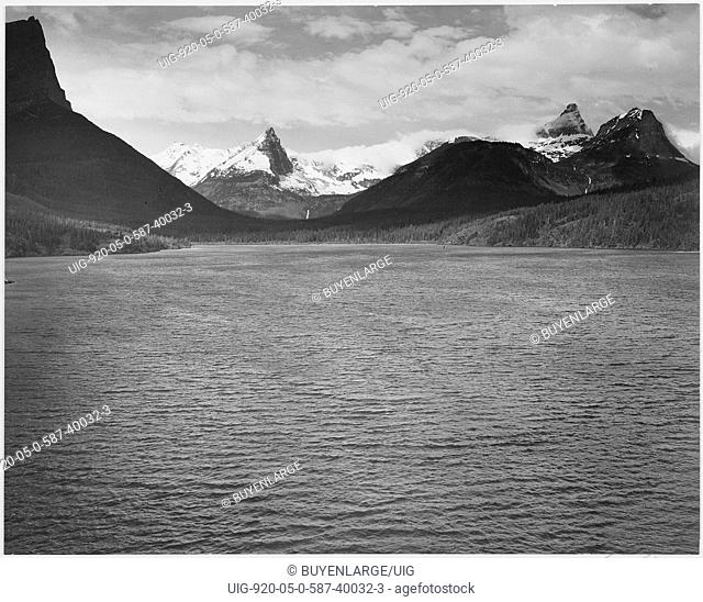 Looking across toward snow-capped mountains lake in foreground St. Mary's Lake Glacier National Park Montana. 1933 - 1942