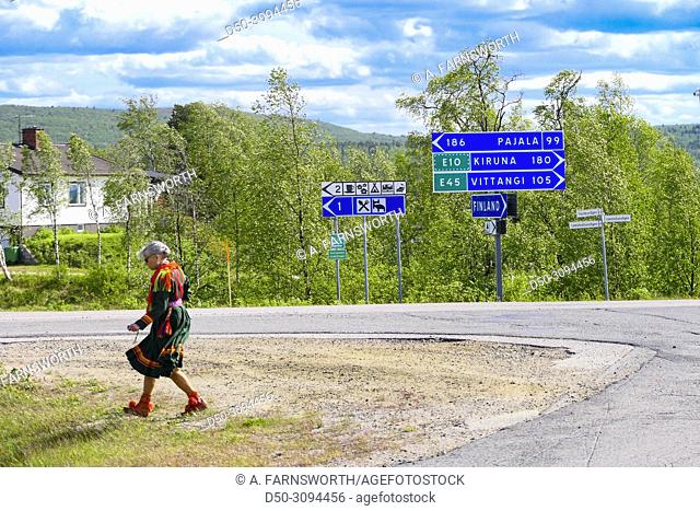 Karesuando, Sweden A Sami woman in traditonal outfit walks across a parking lot in Karesuando, Sweden's northernmost town on the border with Finland