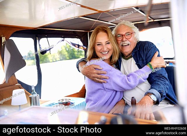 Happy senior couple embracing each other in boat