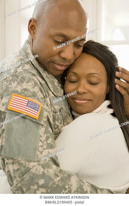African soldier and girlfriend hugging