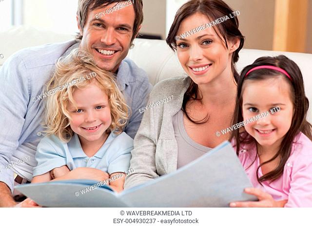 Close up of a family looking at a photo album
