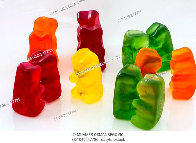 closeup shoot of the color pairs of gummy bears and one lonely bear