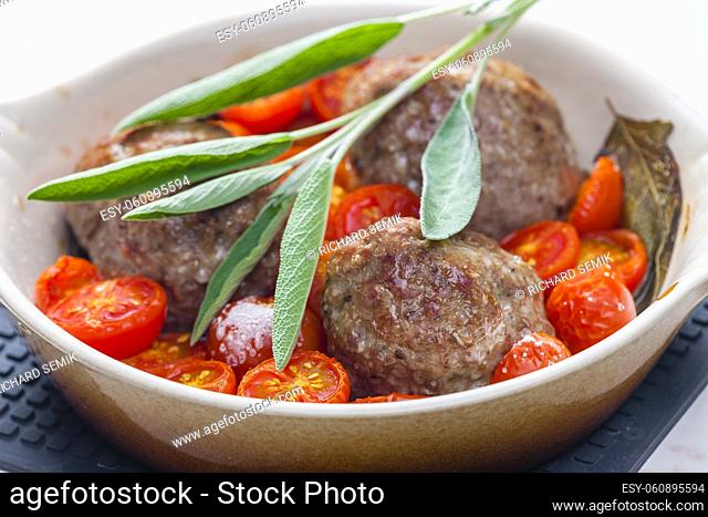 meat balls with tomatoes baked with sage