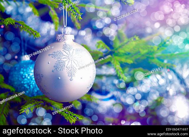 Christmas celebration holiday background - christmas-tree decoration bauble on decorated Christmas tree with defocused blurred lights bokeh and copyspalce