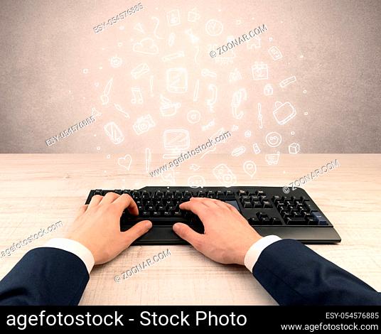 First person view of an elegant businessman hand typing with doodle report and chart concept