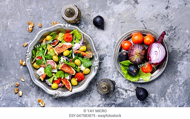 Autumn salad with arugula, olive, figs and cheese.Healthy food.European food