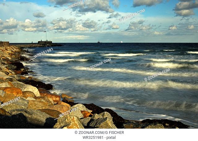 Stürmische Wellen schlagen an einem Herbsttag gegen eine Mole, Ostsee, Deutschland / Stormy waves hitting against a stony mole on an autumn day, Baltic Sea