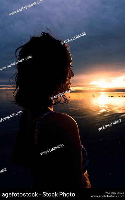 Young woman looking at sunset