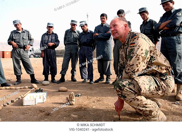 A german ISAF- Stabsfeldwebel at a basic course for and with a group of afghanish police men in house searching in the PRT Feyzabad