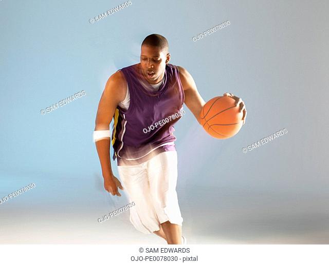 Blurred view of basketball player dribbling