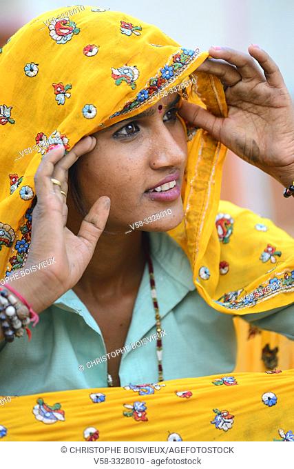 India, Rajasthan, Tonk region, Young Meena woman holding her veil