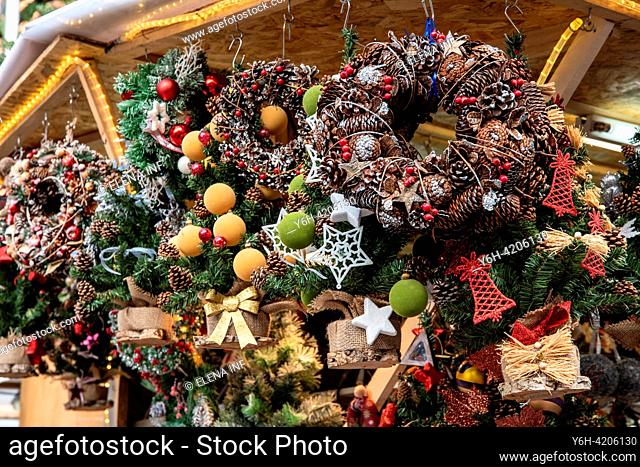 Santa Llucia Market's enchanting corner: A stall brimming with exquisite Christmas wreaths, adding festive charm to Barcelona's holiday spirit