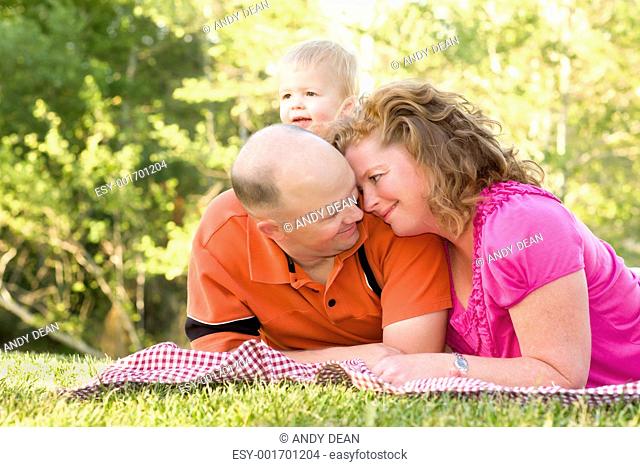 Affectionate Couple with Son in Park