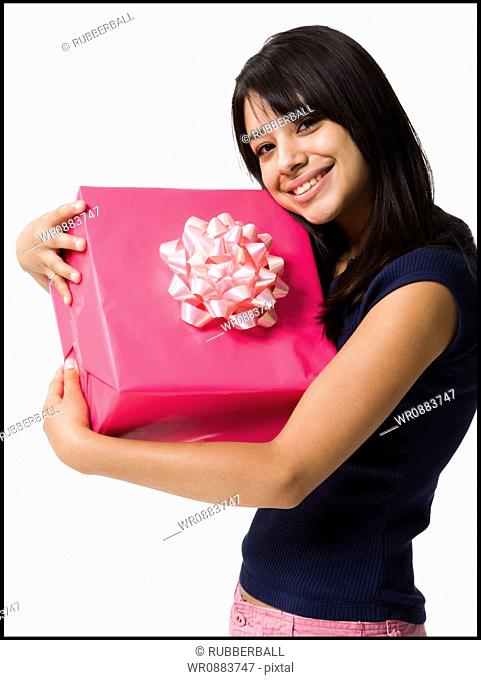 Close-up of a teenage girl holding a gift