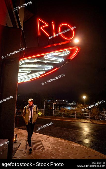 Stockholm, Sweden A man walks under the illuminated marquee of the Bio Rio movie theatre in the Hornstull district at night