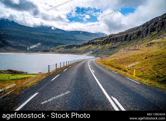 The empty road along the coast and fjord. Beautiful scenery in Iceland