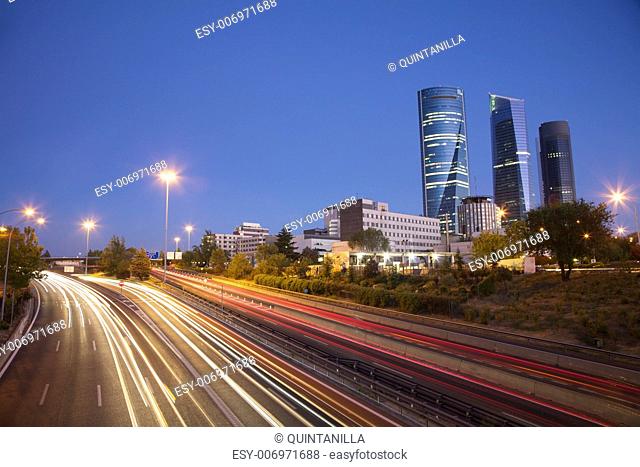evening at highway next to skyscrapers in Madrid city Spain