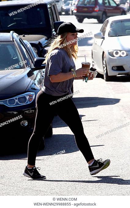 Hilary Duff picks up a couple of coffees on her way to the gym in Beverly Hills, wearing a t-shirt promoting her TV show 'Younger' Featuring: Hilary Duff Where:...