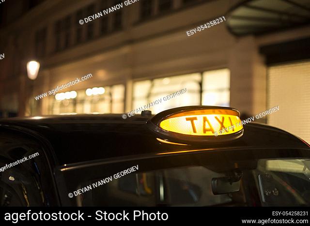 Taxi in London in the night. Close up taxi light